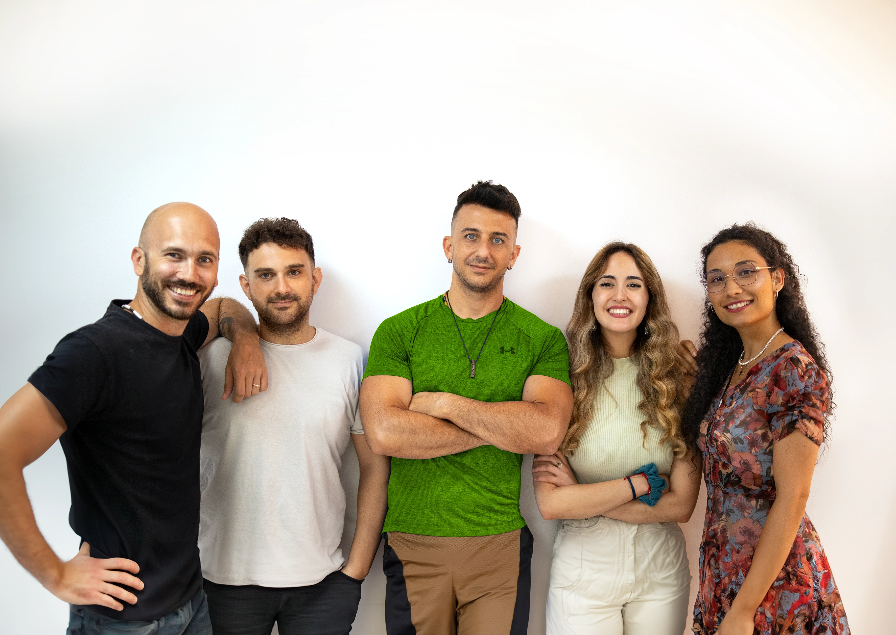 Photo of the development team consisting of five people, including diverse gender identities, collaborating and smiling.